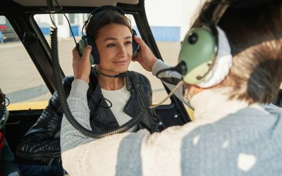 Pretty lady on an aircraft getting assistance from the pilot